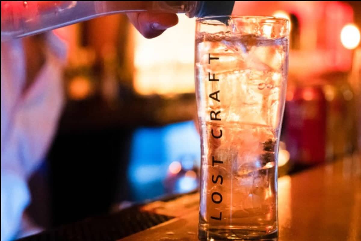 Drink being added to tall glass