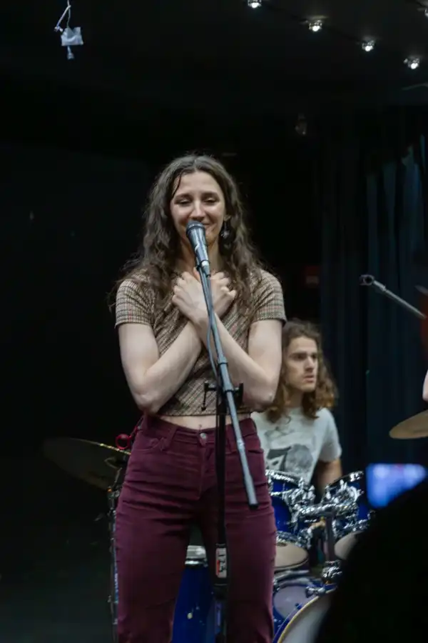 Woman singing hands on chest