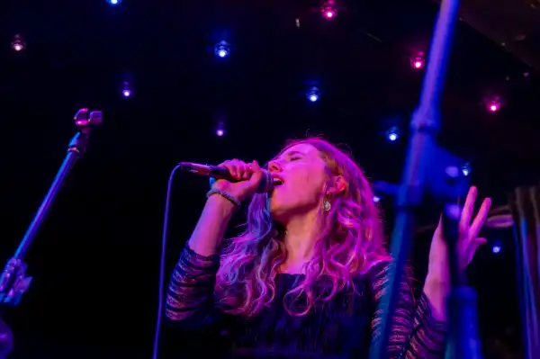 Woman singing with mic to mouth