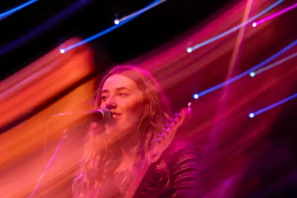 Woman singing in hazy red light